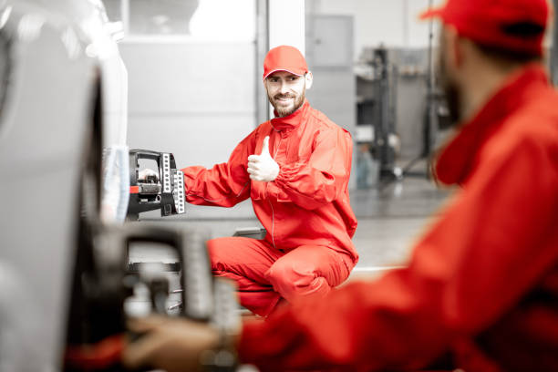 istock Auto mechanics making wheel alignment at the car service 1081594272