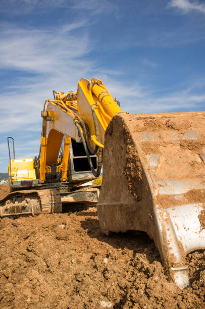 istock Earthmoving excavator preparing the construction site soil 1081596198