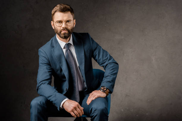 istock successful businessman sitting in glasses and suit 1081599218