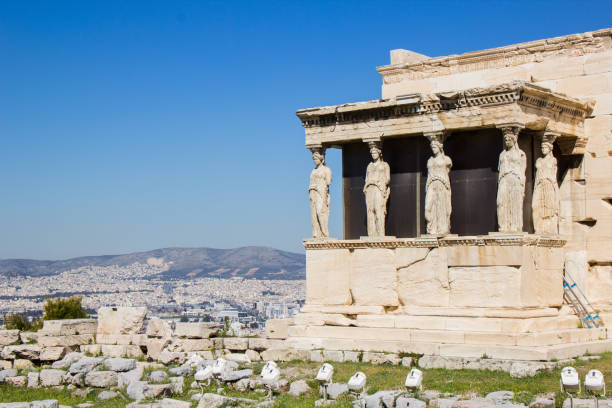 Caryatids at Acropolis A Caryatid is a sculpted female figure serving as an architectural support taking the place of a column or a pillar supporting an entablature on her head. acropole stock pictures, royalty-free photos & images