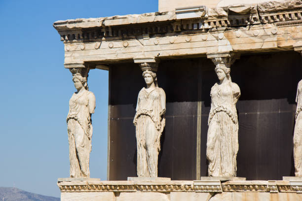 Caryatid and sky at Acropolis A Caryatid is a sculpted female figure serving as an architectural support taking the place of a column or a pillar supporting an entablature on her head. acropole stock pictures, royalty-free photos & images