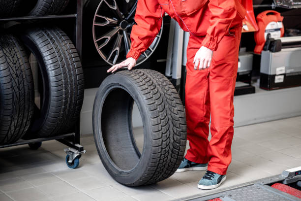 istock Carrying new tires at the service 1081604076