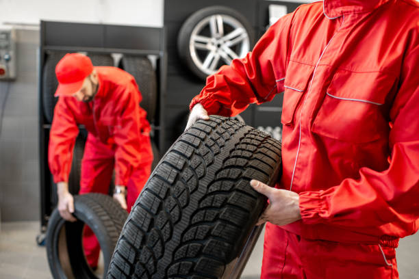 istock Carrying new tires at the service 1081604240