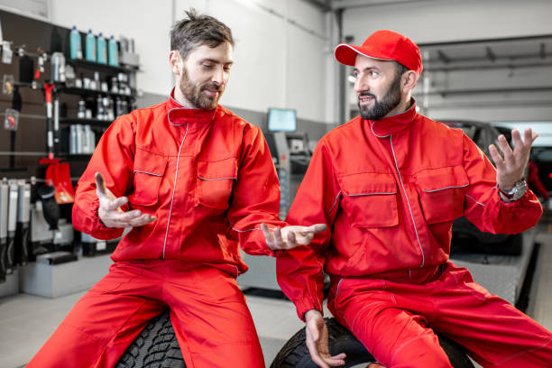istock Car service workers during the break at the tire mounting service 1081604428