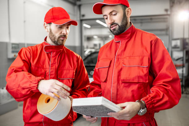 istock Auto mechanic with new and used car air filter 1081605248