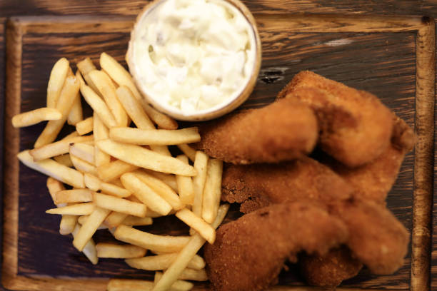 istock Fish and chips on wooden plate 1081606918