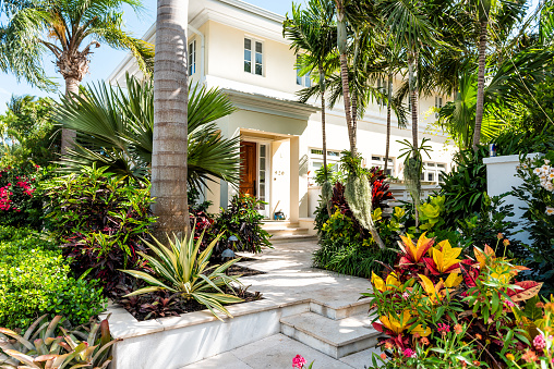 Key West, USA - May 1, 2018: Luxury modern entrance architecture of house in Florida city island on travel, sunny day, property real estate with garden landscaping decoration steps