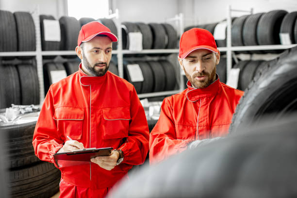 istock Men working in the warehouse with tires 1081609732