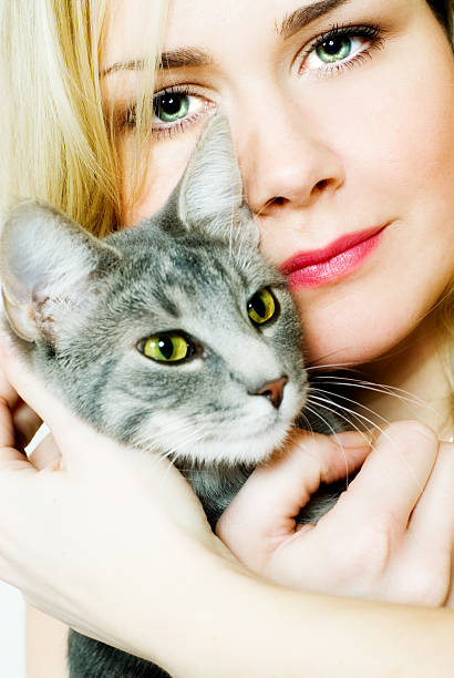 Beautiful white happy woman and cute cat sitting on armchair