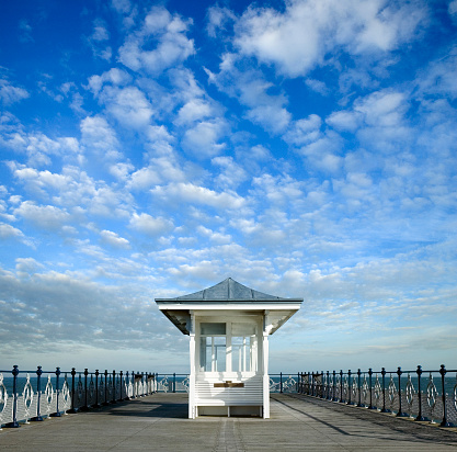 Brighton, Brighton And Hove, East Sussex, Southeastern England, United Kingdom, Britain, Europe - 16th March 2024: Brighton Seafront. The Brighton palace pier structure and facade near the Brighton beach. Some people are also seen from the distance walking on the structure.\n\nLocation: Brighton Palace Pier is located at Madeira Drive, Brighton, BN2 1TW, in the city centre opposite the Old Steine.\n\nIts Structure and Attractions as seen in the photo:\nBrighton Palace Pier, a Grade II listed pleasure pier building, features a variety of attractions including traditional British architecture, modern entertainment facilities, fairground rides, roller coasters, restaurants, arcades, and some Restaurants. a waterfront theme park in England.\n\nThe seafront of Brighton and Hove in England;  a picturesque view of the beach, a sought-after travel destination in the UK. A vibrant atmosphere and charming coastal town appeal, Brighton and Hove's  panoramic view that captivates tourists from all over.