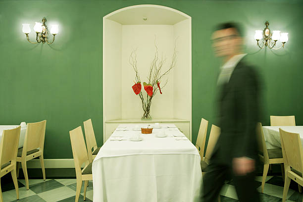 Empty restaurant or cafe with green chairs empty because of the coronavirus crisis - focus on the foreground