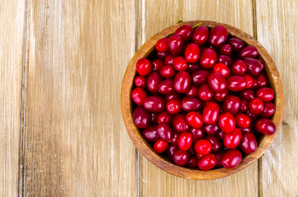 istock Autumn ripe cornel berries on wooden table 1081615750