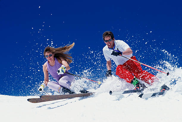 Couple Snow Skiing in Spring stock photo