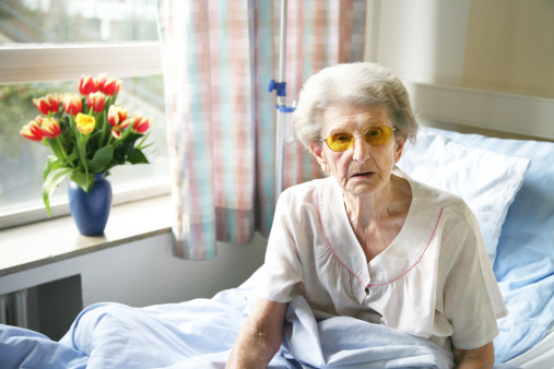 old woman in hospital sitting in her bed