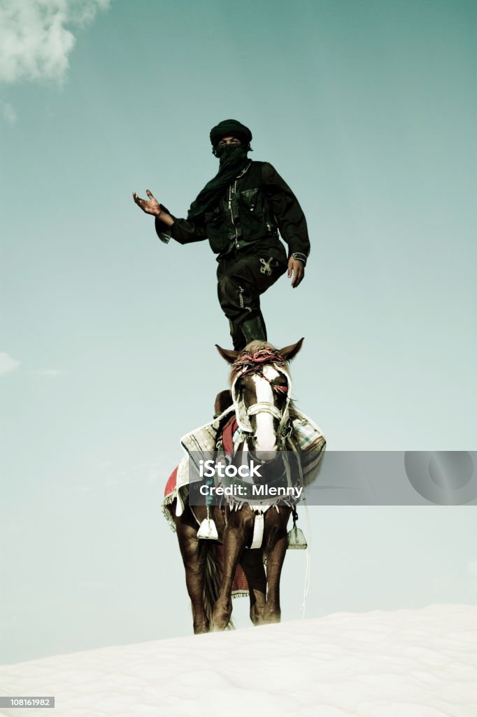 Tuareg Standing on Horse in Sand Dune  Bedouin Stock Photo