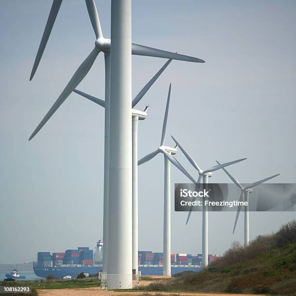 Windmills With Container Ship In A Harbor Stock Photo - Download Image Now - Wind Turbine, Container Ship, Color Image