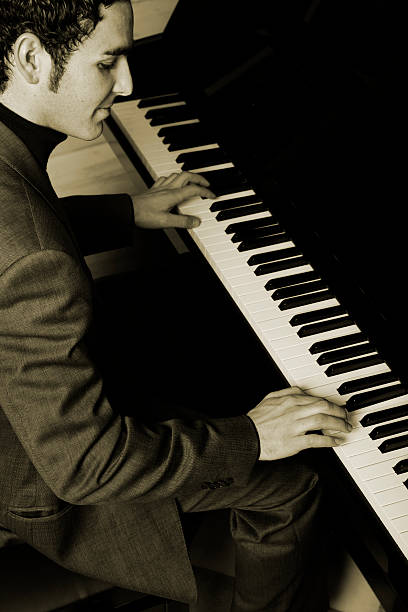 istock Young Man Playing Classical Piano, Sepia Toned 108162313