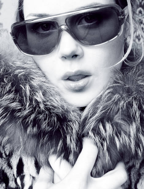 giovane donna che indossa occhiali da sole e collo di pelliccia - distinqushed foto e immagini stock