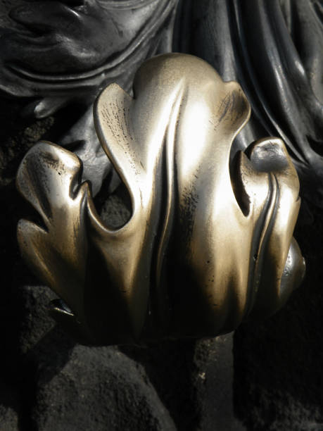 decorative ornate old bronze door handle with stylised leaf design in cold and black tones
