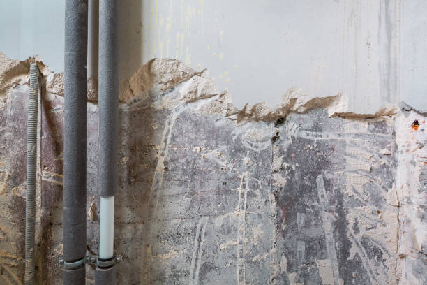 istock Working process of dismantling blonding plaster on the wall  for plumbing pipe before of installing metal frames for plasterboard -drywall - for making gypsum walls  in apartment is under construction, remodeling, renovation, extension, restoration and re 1081625766