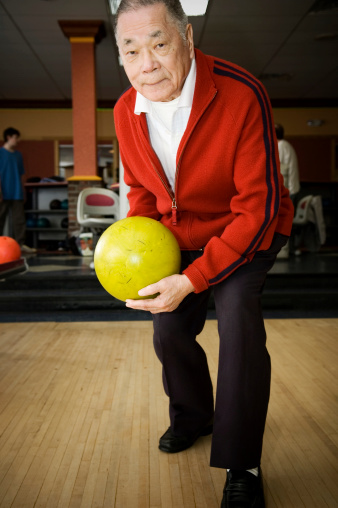 Senior man bowling.