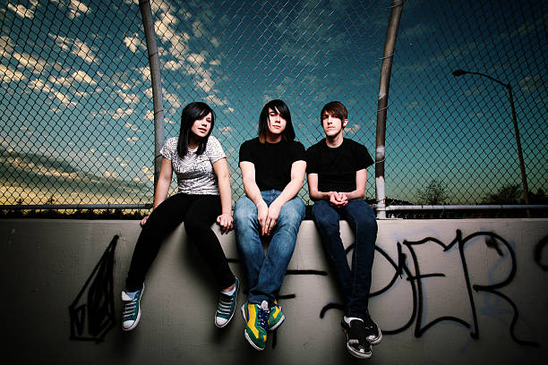 istock Teenagers Sitting by a Fence 108162786
