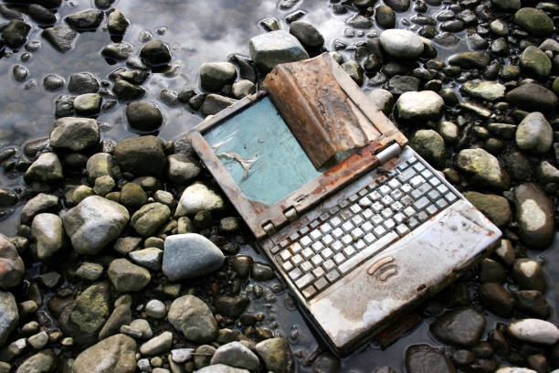 Abandoned and Rusted Laptop Lying on Riverbed  e waste photos stock pictures, royalty-free photos & images