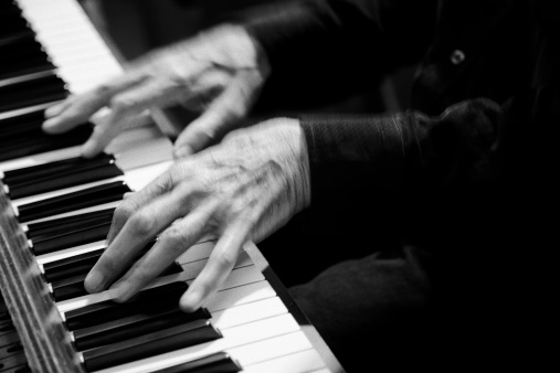 musician plays a melody on the piano