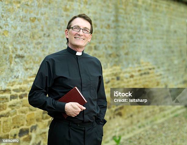 Priest Holding Bible Stock Photo - Download Image Now - Priest, Minister - Clergy, Cheerful