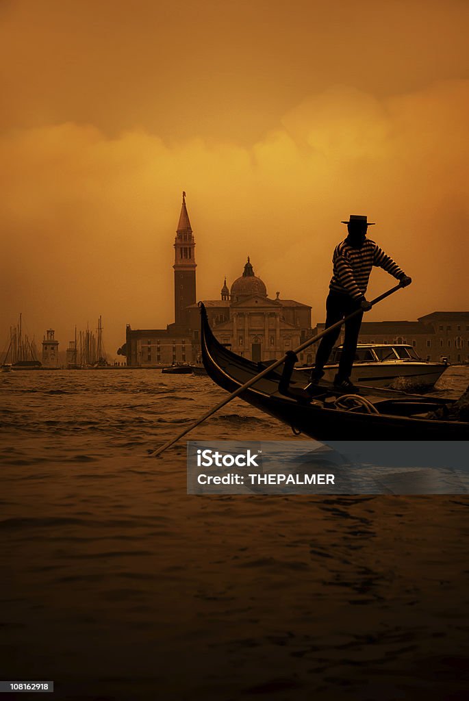 mysterious gondolier a gondolier in the grand canal with the lido palace behind Venice - Italy Stock Photo