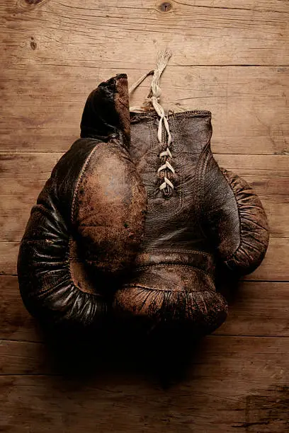 Antique boxing gloves on rustic wooden table