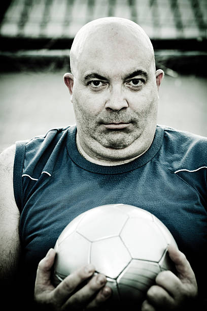 istock Bald Man Holding Soccer Ball 108162929