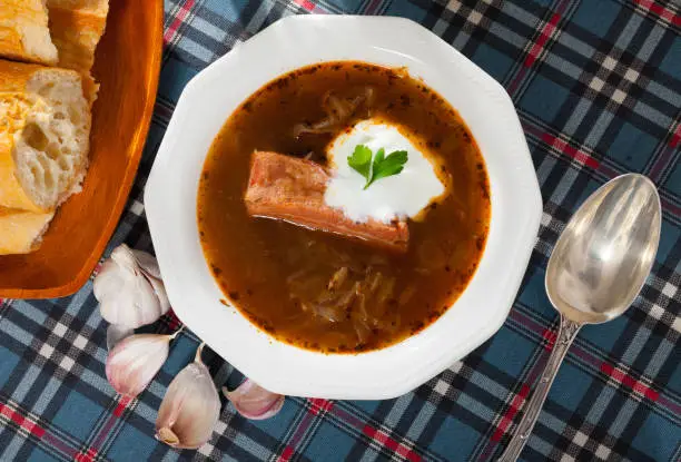 Photo of Shchi on mushroom broth with pork and sour cream