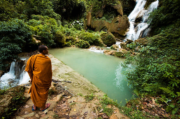istock Monk Viewing Tat Kuang Si Waterfall in Laos 108163008