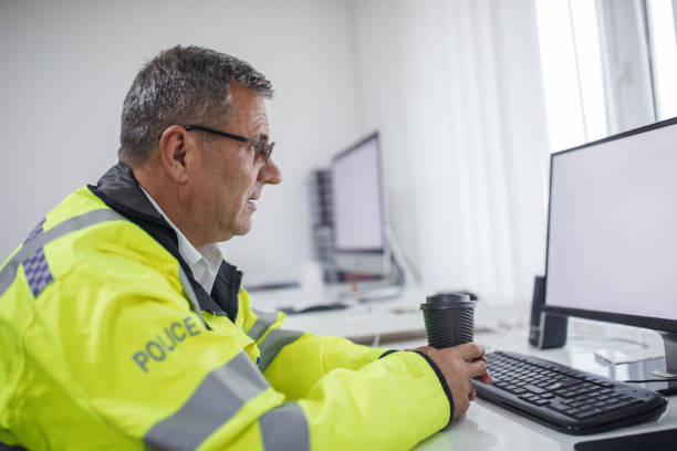 istock Traffic warden drinking coffee at the office 1081630470