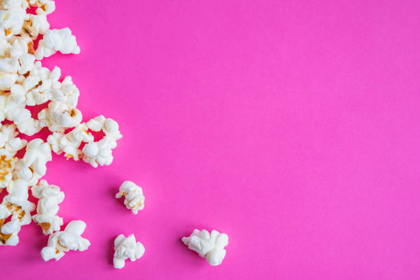 istock Background with a popcorn. Pink background with popcorn. Flat lay, top view. 1081632336