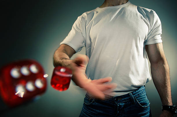 The child is holding a game die and a smartwatch, with a black background.