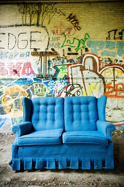 istock Bright Blue Couch Against Cement Wall of Graffiti 108163491
