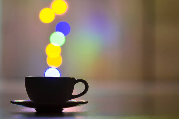 White cup of coffee with colorful bokeh steam