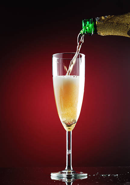Bubbly Champagne Being Poured Into Glass stock photo
