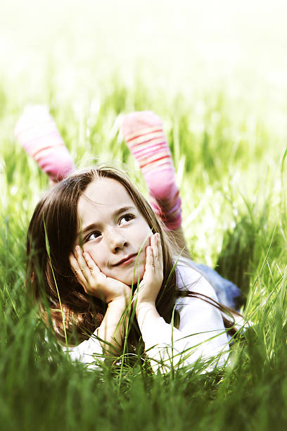 istock Little Girl Lying in Grass on Sunny Day 108163680