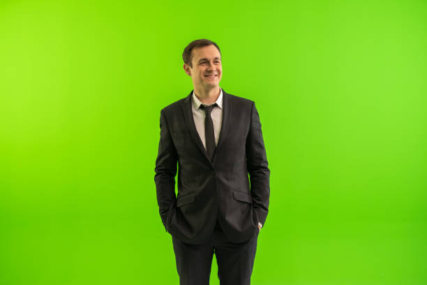 The businessman stand on the green background