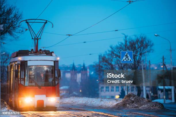 Vitebsk Belarus Public Old Retro Tram Of Route Number Eight Moving Near Private Sector And Old Cathedral Of St Barbara In Evening Night Illuminations At Winter Stock Photo - Download Image Now