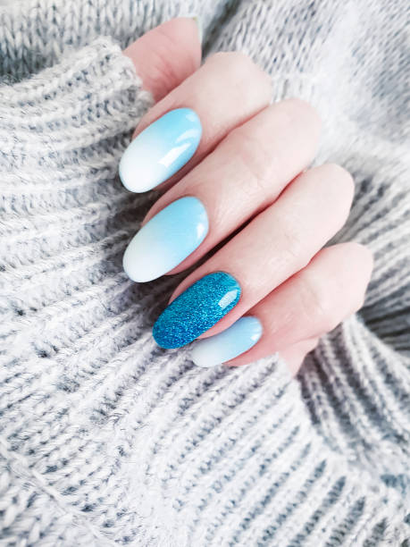 istock female hand beautiful manicure, sweater 1081642190