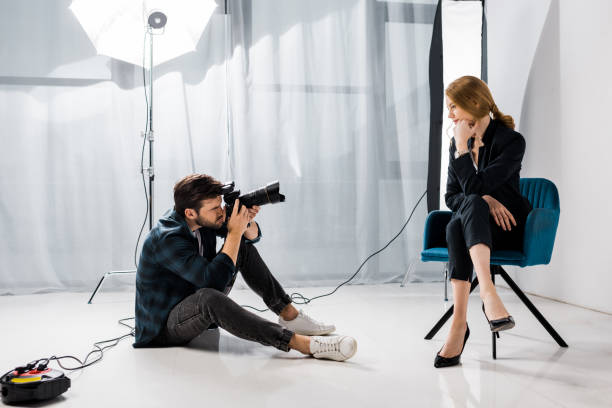 istock young male photographer shooting beautiful model in studio 1081644048