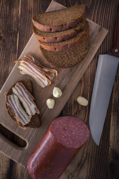 istock bacon and sausage with black bread and garlic on a wooden table 1081644636