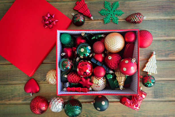 istock Red Box filled with New Year decorations on wooden background. 1081648754