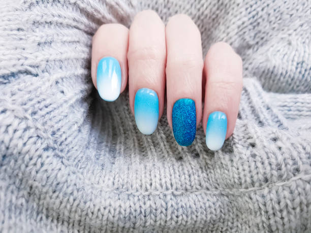 istock female hand beautiful manicure, sweater 1081649252