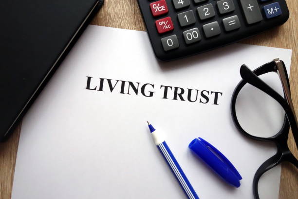 Living trust document Living trust document, pen, glasses and calculator on desk Living trust stock pictures, royalty-free photos & images