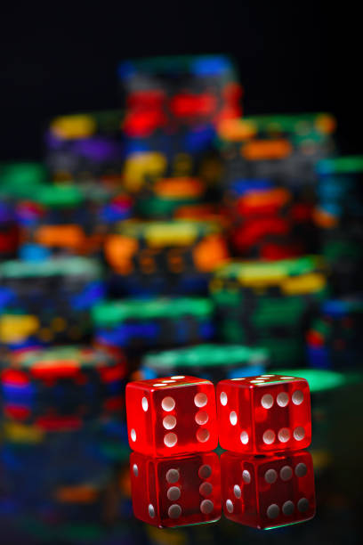 istock casino red dices and colored stack of chips in defocus 1081656932
